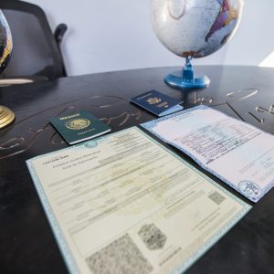 Mexican birth certificates and passports laid out on a table